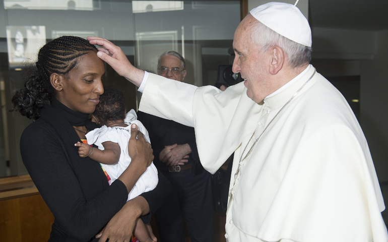 Pope Francis blesses Mariam Ibrahim of Sudan during a private meeting Thursday at the Vatican. (CNS/Reuters/L'Osservatore Romano)