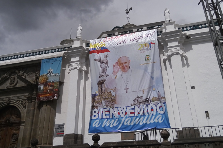 A sign welcoming Pope Francis to Ecuador is seen in Quito's Plaza Grande July 5 (NCR photo/Joshua J. McElwee)