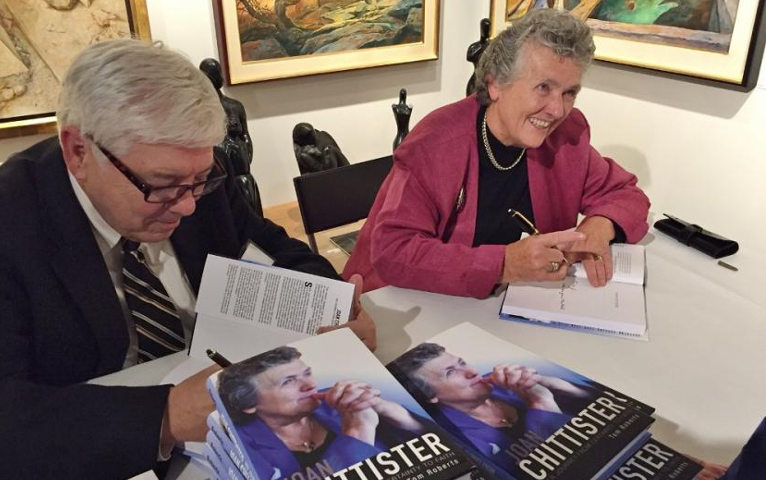 Tom Roberts, author of a biography of Benedictine Sr. Joan Chittister released Oct. 1, sign books with her at a launch event at Pucker Gallery in Boston. (GSR photo / Caitlin Hendel)