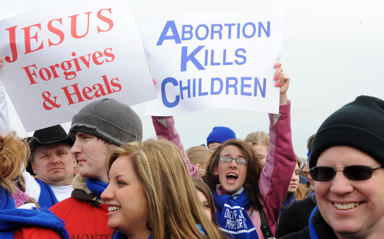 People display signs during the 2010 March for Life rally on the National Mall in Washington. (CNS/Leslie E. Kossoff-Nordby)