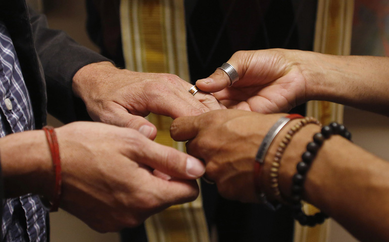 Jim Derrick and Alfie Travassos exchange rings as they get married Monday at the Salt Lake County Government Complex in Salt Lake City. (CNS/Reuters/Jim Urquhar)