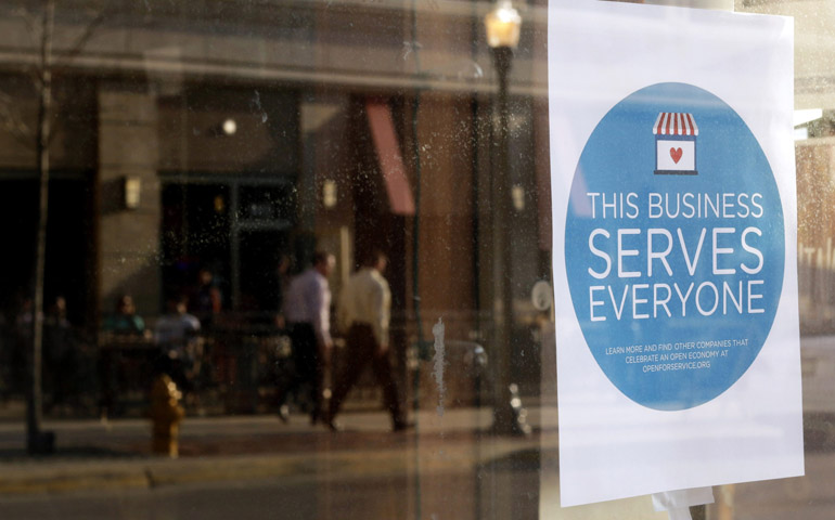 A sign in the window of a barbershop in downtown Lafayette, Ind., on Tuesday (CNS/Reuters/Nate Chute)