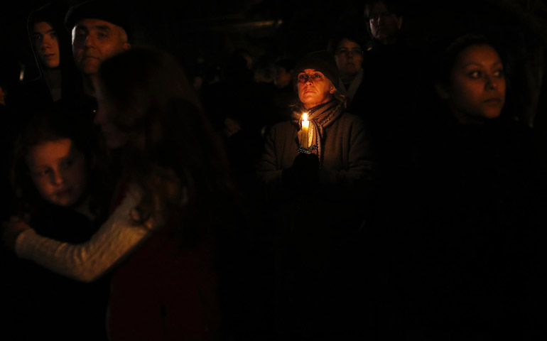 People take part in a Dec. 14, 2012, vigil outside St. Rose of Lima Church in Newtown, Conn., after the shootings at Sandy Hook Elementary School. A gunman opened fire on children and staff at the school, killing at least 27 people, including 20 children. (CNS/Reuters/Shannon Stapleton)