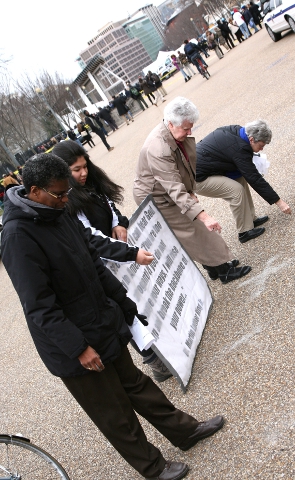 Participants in an Ash Wednesday service hosted by the Dorothy Day Catholic Worker Community spread ashes outside the White House in a call for repentance Feb. 14 (Photo courtesy of Ted Majdosz)