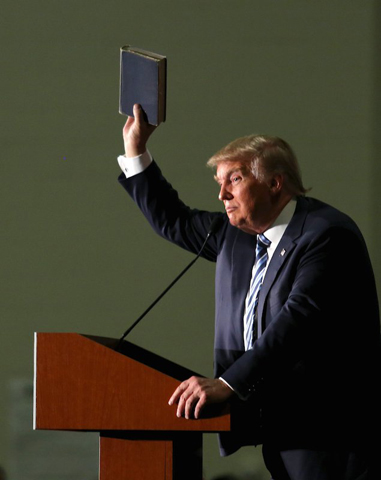 Republican presidential candidate Donald Trump holds up a copy of the Bible he said his mother gave him as a youth during a campaign rally in Council Bluffs, Iowa, on Dec. 29, 2015. (Reuters/Lane Hickenbottom)