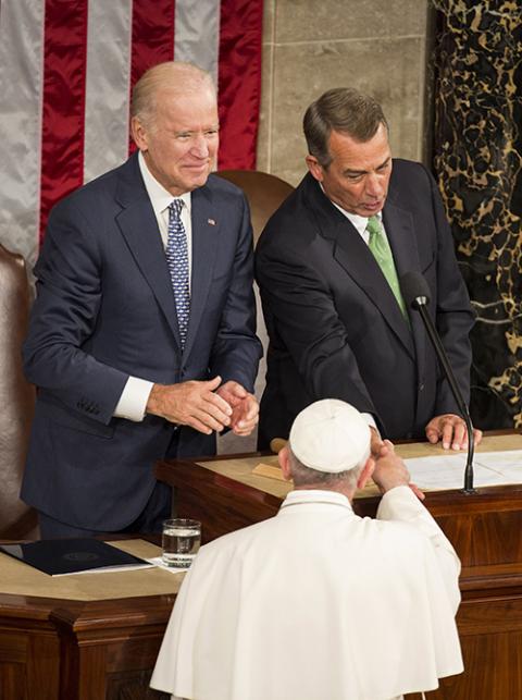 Pope Francis shakes hands with then-U.S. Speaker of the House John Boehner as then-U.S. Vice President Joe Biden looks on during a joint meeting of Congress on Capitol Hill Sept. 24, 2015, in Washington. (CNS/Joshua Roberts)
