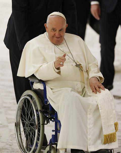 Pope Francis gives a thumbs up as he rides in a wheelchair during his general audience in the Paul VI hall Dec. 7, 2022 at the Vatican. (CNS/Paul Haring)