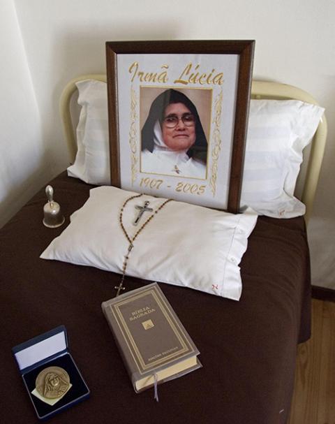 A portrait of Sr. Lúcia dos Santos, her Bible and her rosary lie on her bed in the Carmelite cloister in Coimbra, Portugal, in 2006. Dos Santos, who died in 2005, was declared "venerable" on June 22, 2023, by Pope Francis. (OSV News/Reuters) 