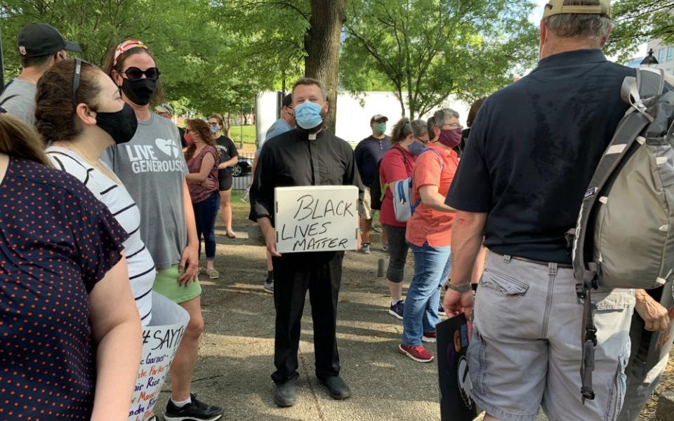 Fr. Joshua Laws, pastor of the Catholic Community of South Baltimore, holds a "Black Lives Matter" sign before the start of an interfaith prayer vigil in Baltimore June 3 to pray for justice and peace following the May 25 death of George Floyd. (CNS)