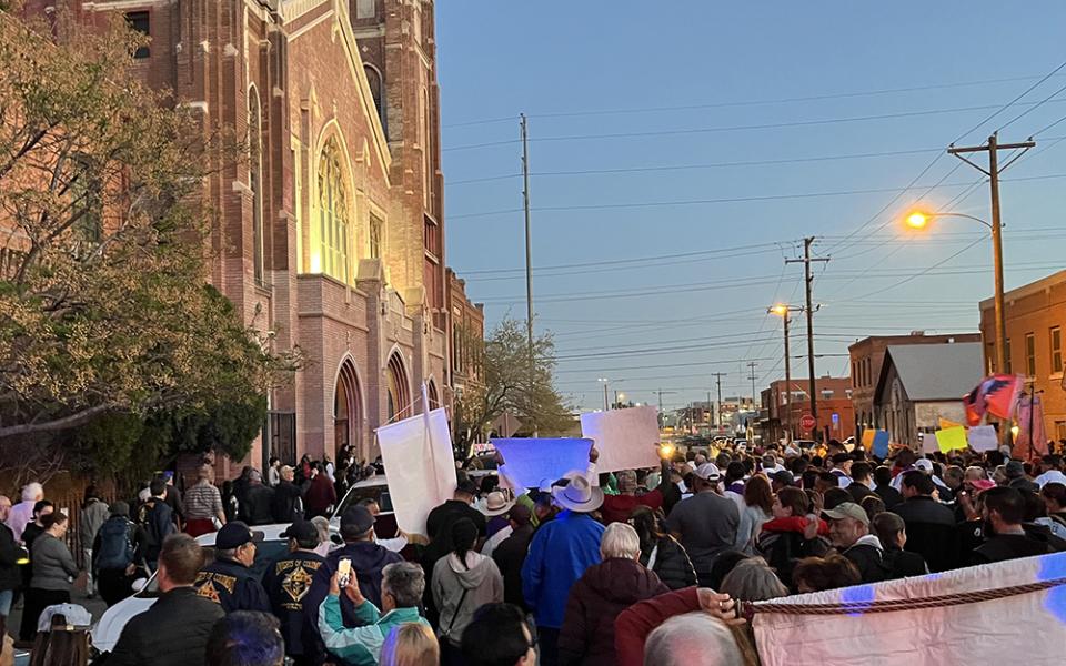 Participants in El Paso's "Do Not Be Afraid: March and Vigil for Human Dignity" await entry into Sacred Heart Catholic Parish, where a vigil was being held to mark the one-year anniversary of the 2023 Ciudad Juarez migrant detention center fire. (Evan Bednarz)