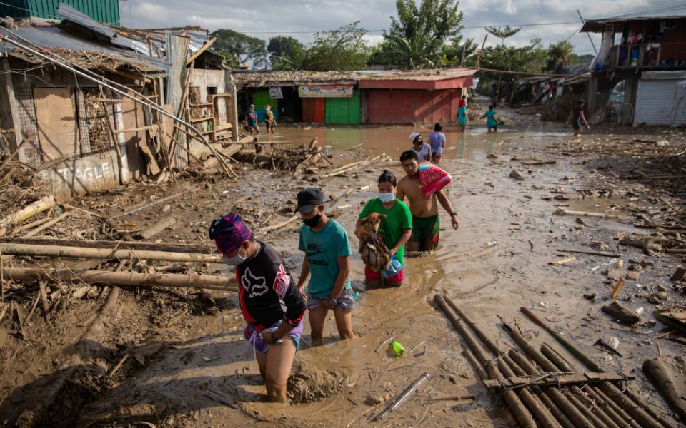 Residents walk through mud in Manila, Philippines, Nov. 14, 2020, after flooding caused by Typhoon Vamco. (CNS/Reuters/Eloisa Lopez)