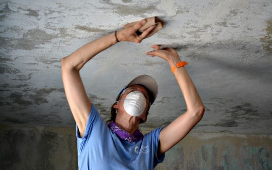 Beth Hood, a member of St. Camillus Parish in Silver Spring, Maryland, helps repair a house in Maunabo, Puerto Rico, July 27. (CNS/Wallice J. de la Vega)