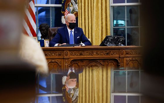 President Joe Biden signs executive orders at the White House Feb. 2 in Washington. (CNS/Tom Brenner, Reuters)