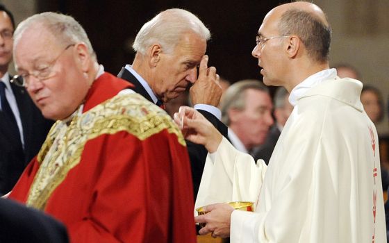 U.S. Vice President Joe Biden makes the sign of the cross after receiving Communion during a Mass at the Basilica of the National Shrine of the Immaculate Conception in Washington in this Sept. 14, 2011, file photo. (CNS/Leslie E. Kossoff)