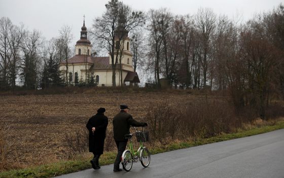 People in Kalinowka, Poland, walk to Mass in a file photo. (CNS/Reuters/Kacper Pempel)