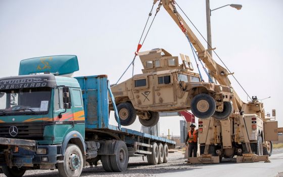 U.S. Army soldiers and contractors load a military vehicle for transport as U.S. forces prepare for withdrawal, in Kandahar, Afghanistan, July 13, 2020. (CNS/U.S. Army Sgt. Jeffery J. Harris handout vis Reuters)