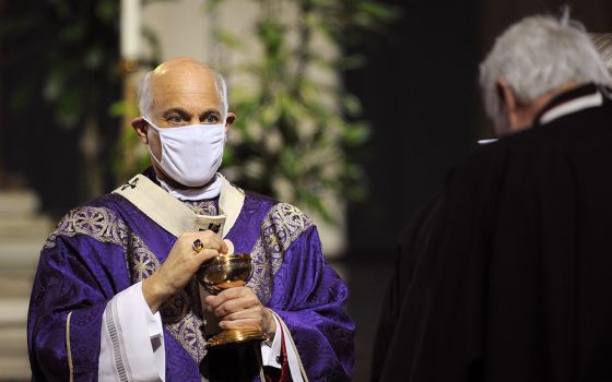 Archbishop Salvatore Cordileone distributes Communion during a Mass for the homeless at San Francisco's Cathedral of St. Mary of the Assumption Nov. 6, 2021. (CNS/David Maung)
