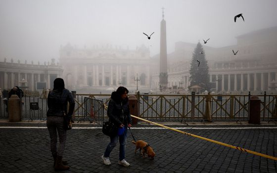 People walk near St. Peter's Square on a foggy day ahead of Pope Francis' celebration of Mass marking the feast of Mary, Mother of God, at the Vatican Jan. 1, 2022. (CNS/Reuters/Guglielmo Mangiapane)