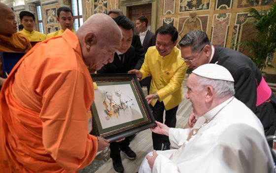 Pope Francis receives a sketch during meeting with a delegation of Buddhists from Thailand in Clementine Hall at the Vatican June 17, 2022. (CNS/Vatican Media)