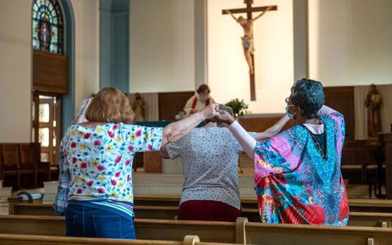 A handful of parishioners in the Gardenville neighborhood of Baltimore attend daily Mass Sept. 16, 2022, at St. Anthony of Padua Catholic Church. (CNS/Catholic Review/Kevin J. Parks)