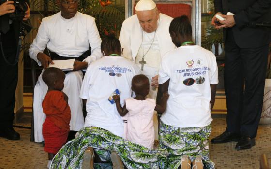 Pope Francis blesses Bijoux Mukumbi Kamala, her twin daughters and her friend Legge Kissa Catarina during a meeting with victims of violence from eastern Congo in the apostolic nunciature in Kinshasa Feb. 1. (CNS/Paul Haring)