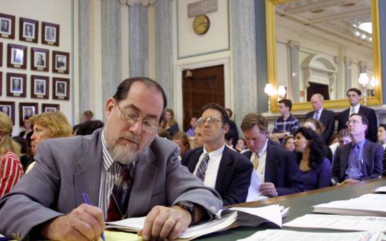 Jerry Filteau, a veteran reporter with Catholic News Service, is seen during a congressional hearing on human cloning on Capitol Hill in Washington in 2001. Filteau, whose byline has become associated with in-depth and authoritative reporting on the Catholic Church, is retiring from CNS July 1 after 37 years. (CNS file photo/Nancy Wiechec) 