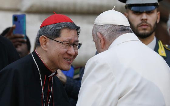 Pope Francis talks with Cardinal Luis Antonio Tagle after praying in front of a Marian statue at the Spanish Steps in Rome Dec. 8, 2022, the feast of the Immaculate Conception. (CNS/Paul Haring) 