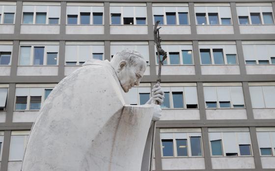 A statue of St. John Paul II is seen in the courtyard of Rome's Gemelli Hospital March 30, 2023, where Pope Francis was admitted March 29 due to concerns over breathing difficulties. He was diagnosed with a "respiratory infection," according to the Vatican. A March 30 update from the Vatican said the pope was "steadily improving" and continuing his planned course of treatment. (OSV News photo/Remo Casilli, Reuters)