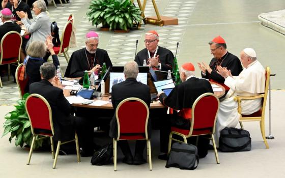Pope Francis and leaders of the assembly of the Synod of Bishops applaud at the conclusion of the gathering's last working session of the synod on synodality Oct. 28 in the Paul VI Hall at the Vatican. (CNS/Vatican Media)