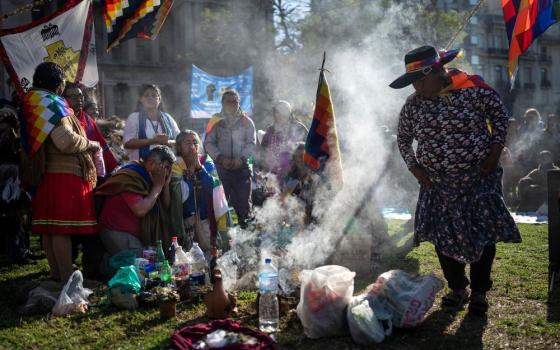 Indigenous leaders from the province of Jujuy perform a ceremony in front of the Palace of Justice during celebrations of "La Pachamama," or Mother Earth Day, in Buenos Aires, Argentina, Tuesday, Aug. 1, 2023. The group's protest, which coincides with La Pachamama, is also directed against a provincial constitutional reform they claim is an attempt against their ancestral rights to lands that the state aims to use for lithium mining. (AP Photo/Rodrigo Abd)