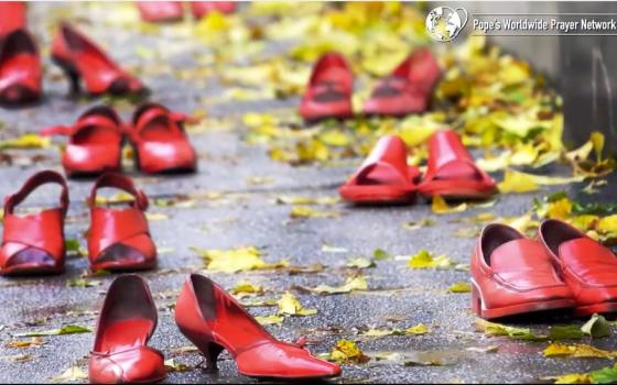 Red shoes, scattered along pavement, accented by yellow, fall leaves