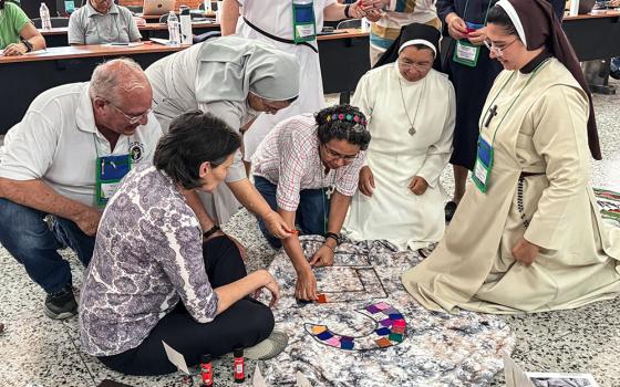 Members of the Confederation of Latin American and Caribbean Religious, known as CLAR for its Spanish acronym, put together an altar decoration April 18 at the Catholic University campus in Las Tres Rosas, Honduras. Some 60 general secretaries, presidents of religious conferences and theologians representing the board of the largest organization of women and men religious in Latin America and the Caribbean gathered for its annual meeting to talk about consecrated life in the region. (GSR photo/Rhina Guidos)