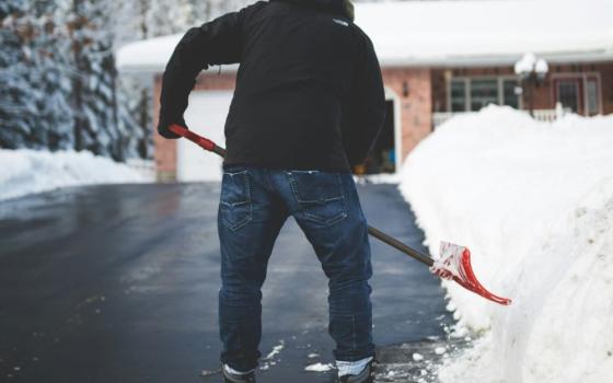 Person shovels snow.