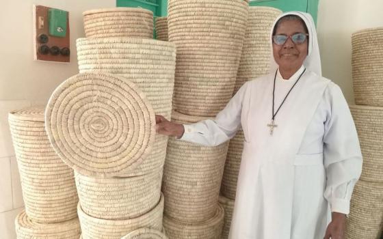 Sr. Jacinta Costa, a member of the Sisters of Charity of Sts. Bartolomea Capitanio and Vincenza Geroza, stands with products women make at Valerian Handicrafts Centre in Jessore, Bangladesh. 
