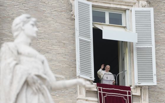 Pope Francis waves to faithful on the occasion of the Angelus noon prayer in St. Peter's Square, at the Vatican, Sunday, Nov. 14, 2021. (AP Photo/Gregorio Borgia)