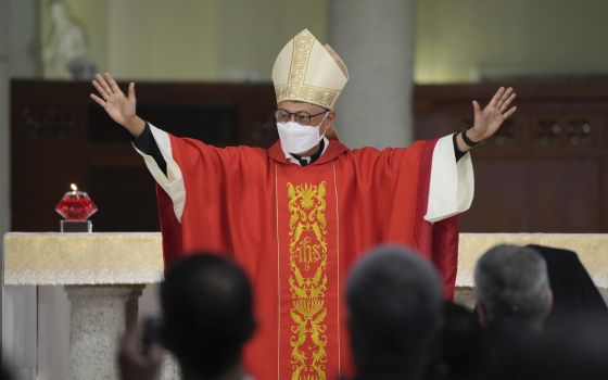 Stephen Chow waves at the episcopal ordination ceremony as the new Bishop of the Catholic Diocese, in Hong Kong, Saturday, Dec. 4, 2021. (AP Photo/Kin Cheung)