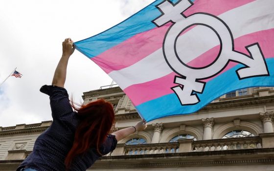 A person in New York City holds up a transgender rights flag Oct. 24, 2018. (CNS/Reuters/Brendan McDermid)