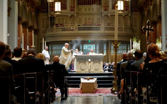 Fr. Michael Ryan, pastor of Seattle's St. James Cathedral, incenses the altar at the beginning of the Aug. 1 funeral Mass for former Seattle Archbishop Raymond Hunthausen. (M. Laughlin)