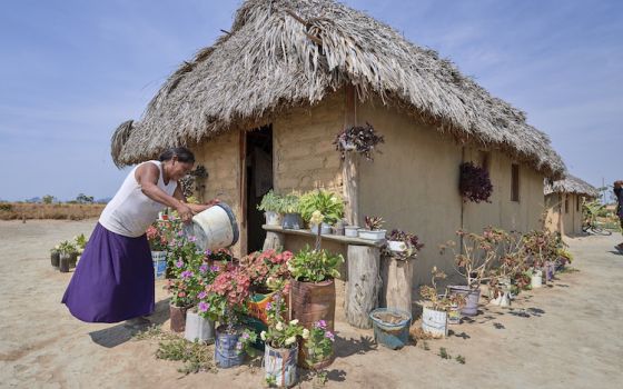 Celestina Fernandes da Silva, a Catholic activist, waters flowers in front of her home in the Wapishana indigenous village of Tabalascada, Brazil, April 3, 2019. (CNS/Paul Jeffrey)