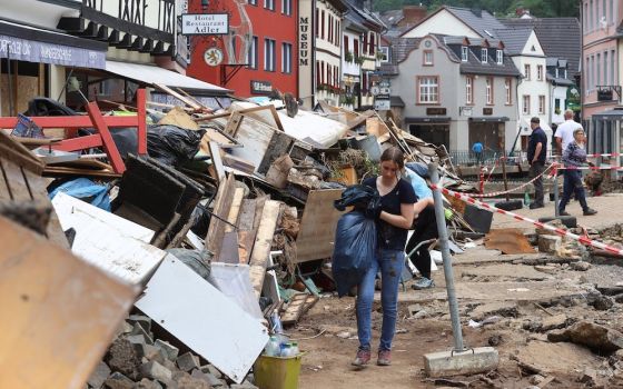 People walk through an area affected by flooding in Bad Münstereifel, Germany, July 19. Nearly 200 people have been confirmed dead, while dozens of others remain missing. (CNS photo/Wolfgang Rattay, Reuters)