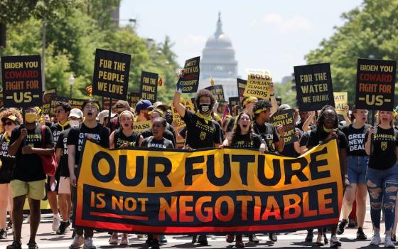 Young climate activists march toward the White House in Washington June 28. (CNS photo/Evelyn Hockstein, Reuters)