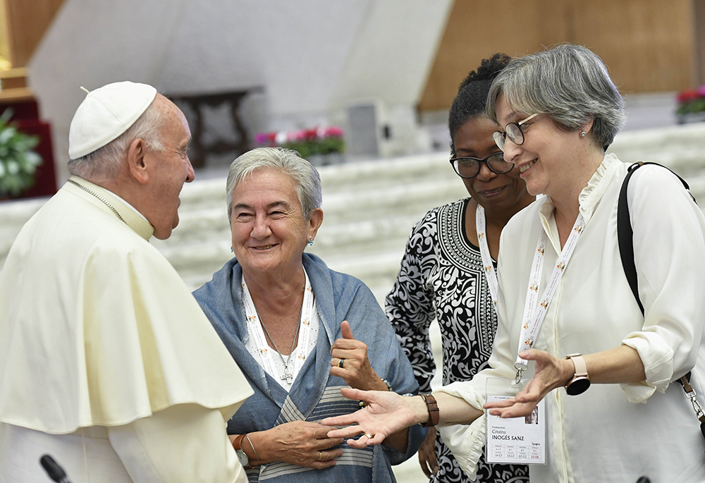 Pope Francis shares a laugh with some of the women members of the assembly of the Synod of Bishops, including Spanish theologian Cristina Inogés Sanz, left, at the assembly's session Oct. 6, 2023, in the Paul VI Audience Hall at the Vatican. (CNS/Vatican Media)