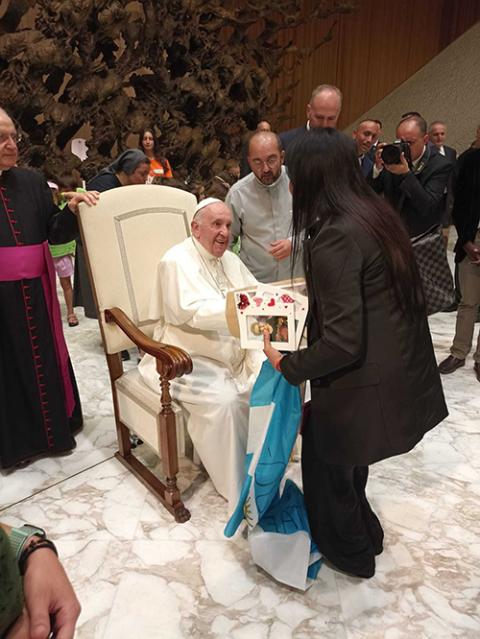 Fr. Andrea Conocchia, center, introduces members of the Torvaianica transgender community to Pope Francis on Aug. 11, 2022, during the pope’s general audience at the Vatican. (Photo courtesy of Andrea Conocchia)