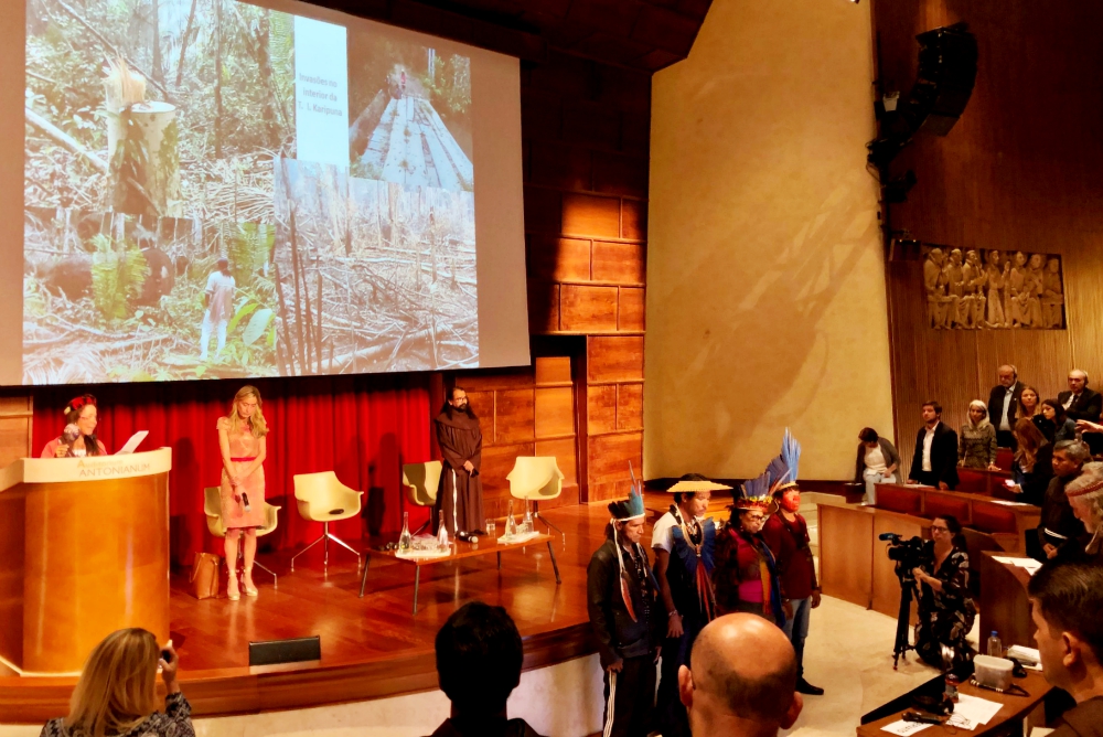 Franciscan Catechist Sr. Laura Vicuña, left, from the indigenous Karipuna community in Brazil, leads a prayerful chant as other indigenous leaders stand before the audience at the Oct. 5 event "Voices of the Amazon." (NCR photo/Soli Salgado)