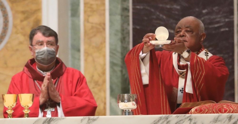 Washington Cardinal Wilton D. Gregory elevates the Eucharist during the 69th annual Red Mass at the Cathedral of St. Matthew the Apostle in Washington Oct. 3. (CNS/Catholic Standard/Andrew Biraj)