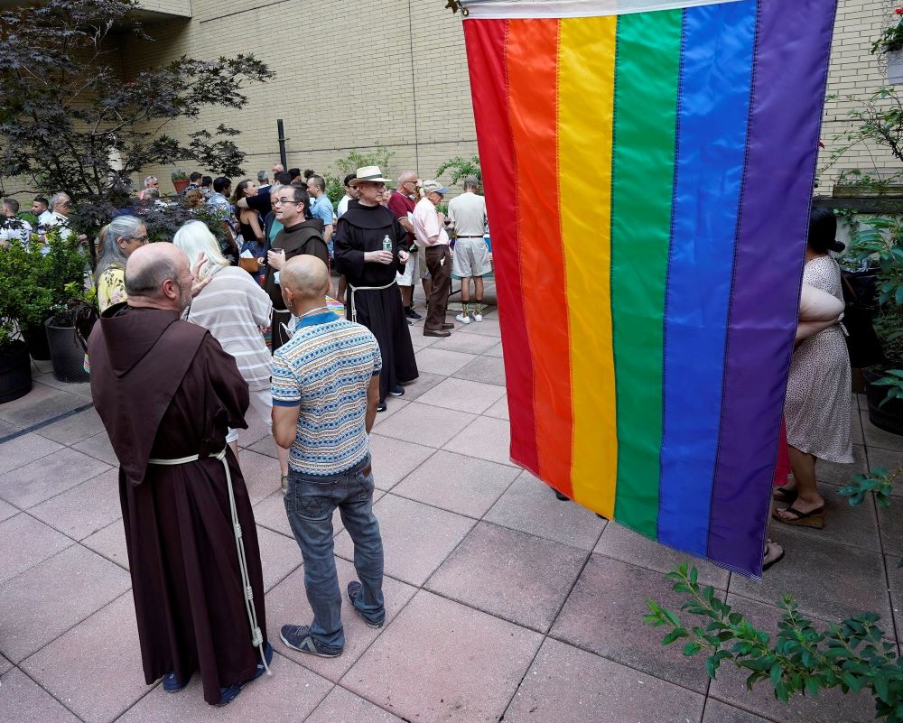 Franciscan friars of St. Francis of Assisi Church in New York City and members of the parish's LGBTQ ministry gather at a reception following an annual "Pre-Pride Festive Mass" June 26. (CNS/Gregory A. Shemitz)