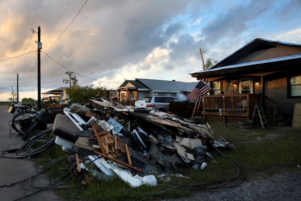 Debris and electrical wires are piled up in a front yard in Chauvin, La. Many homes in the community were damaged or destroyed by Hurricane Ida, which made landfall in late August. (AP/Jessie Wardarski)