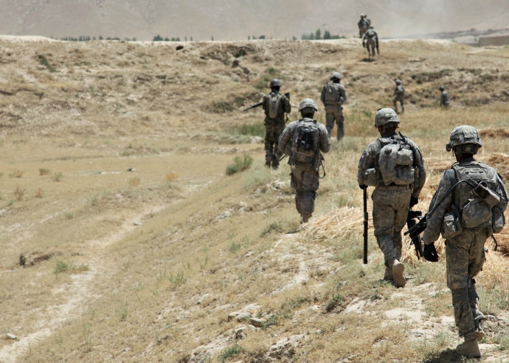 U.S. Army soldiers, alongside Afghanistan National Army soldiers, patrol through the village of Baraki Barak, Logar province, on July 6, 2011. (Wikimedia Commons/U.S. Department of Defense)