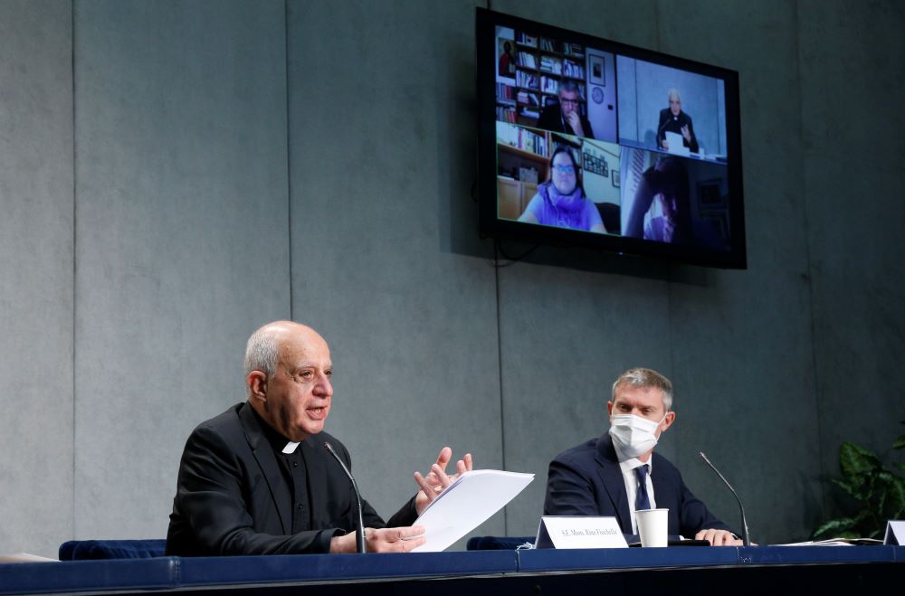 Archbishop Rino Fisichella, president of the Pontifical Council for Promoting New Evangelization, and Matteo Bruni, director of the Holy See Press Office, participate in a news conference for the release of a papal document. (CNS/Paul Haring)