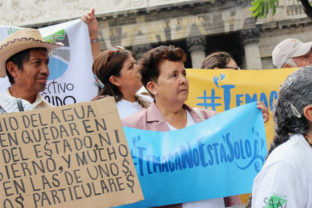  "Temaca, You Are Not Alone": Guadalupe Lara holds up a sign in defense of Temacapulín, another Jalisco village threatened by a dam, at July 2019 press conference in Guadalajara by the Mexican Institute for Community Development. (Tracy L. Barnett)